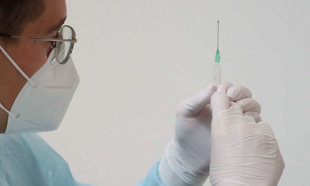 Impfung / Arzt mit Nadel